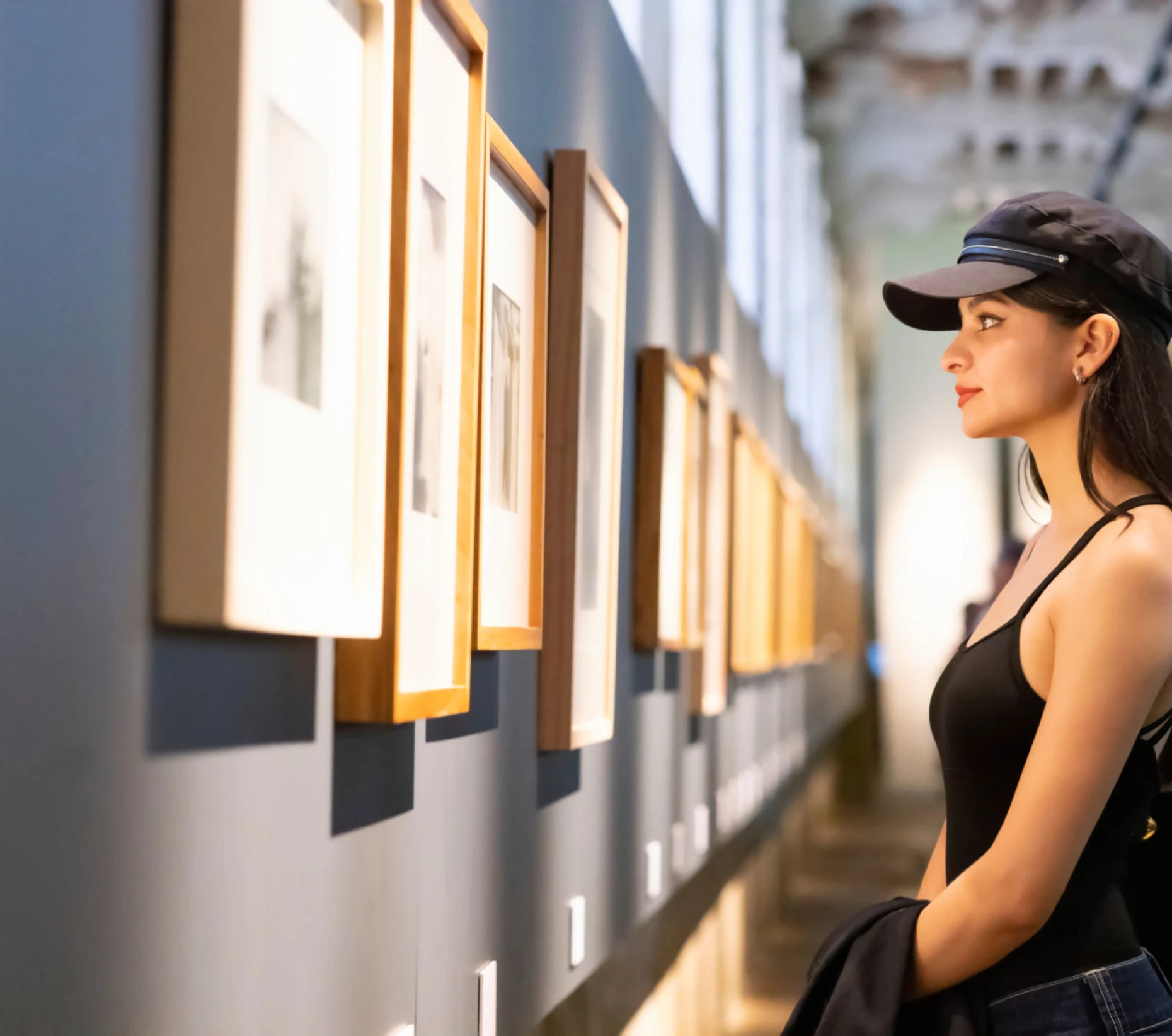 Woman observing art in a gallery.